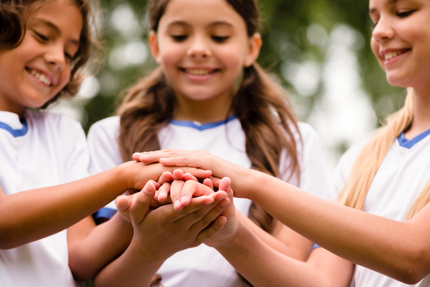 Young people joining hands together