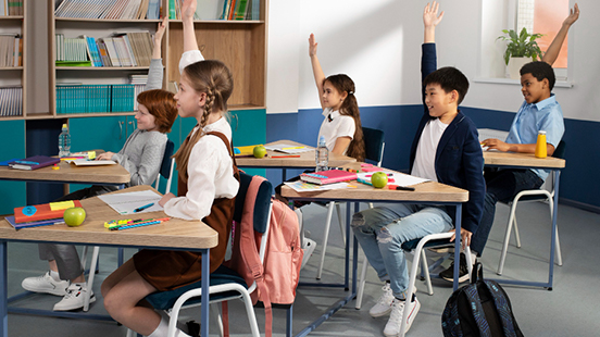 Children raising hands in a classroom