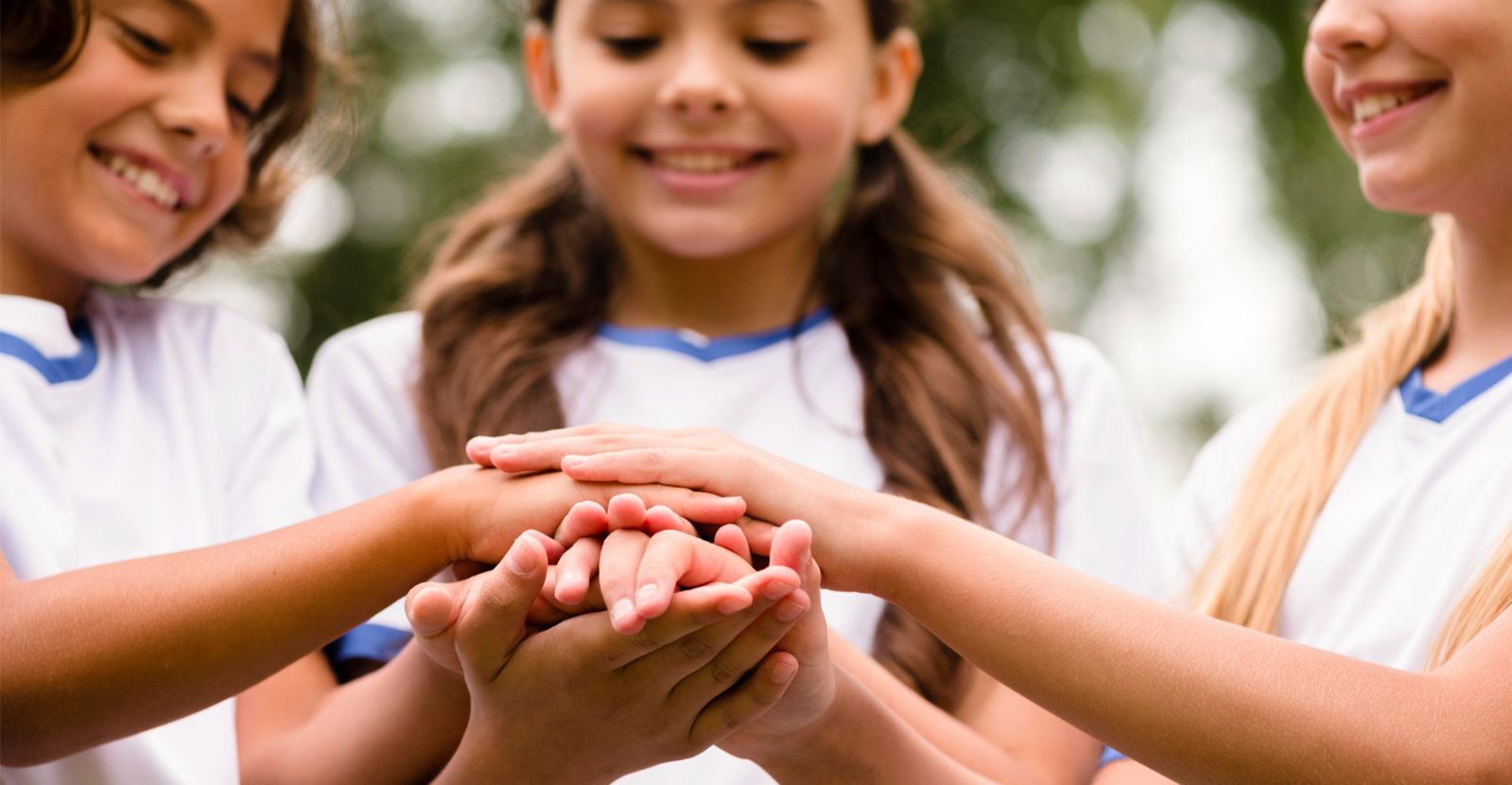 Young people joining hands in support